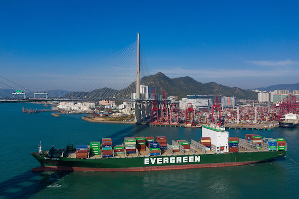 Hong Kong harbour with Evergreen container ship Hong Kong Evergreen Containership - image by Leungchopan/shutterstock.com